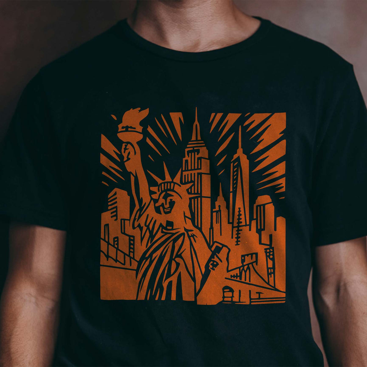 New York Skyline Landmark Stencil stands out on a black shirt with Lady Liberty and city towers.
