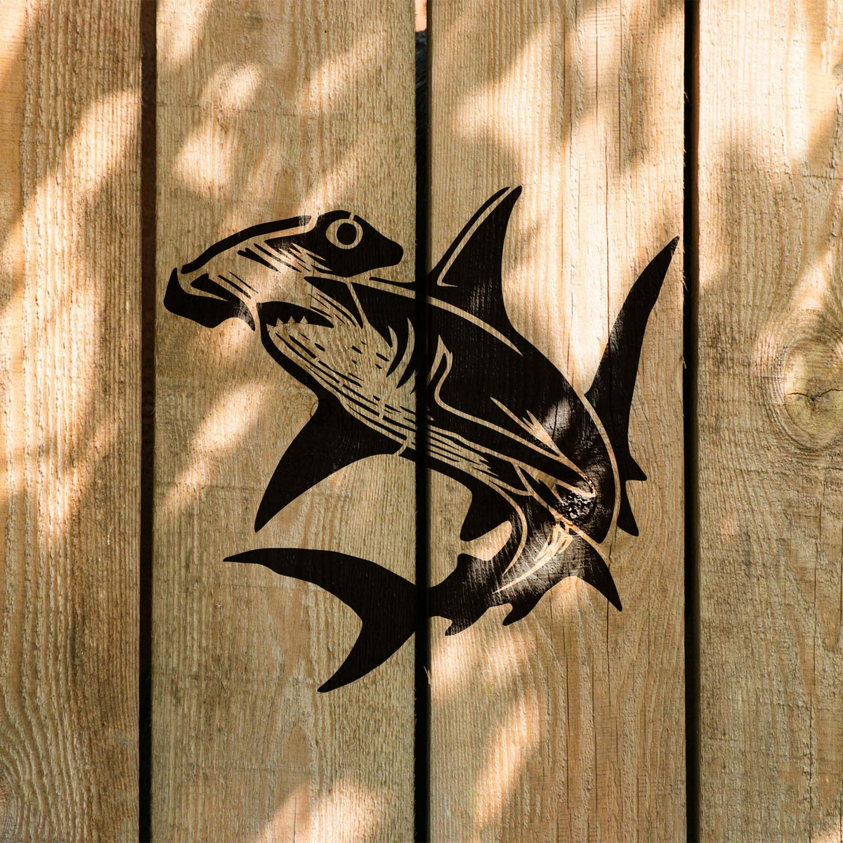 Detailed Ocean Hammerhead Shark Stencil stands out across sunlit wooden boards