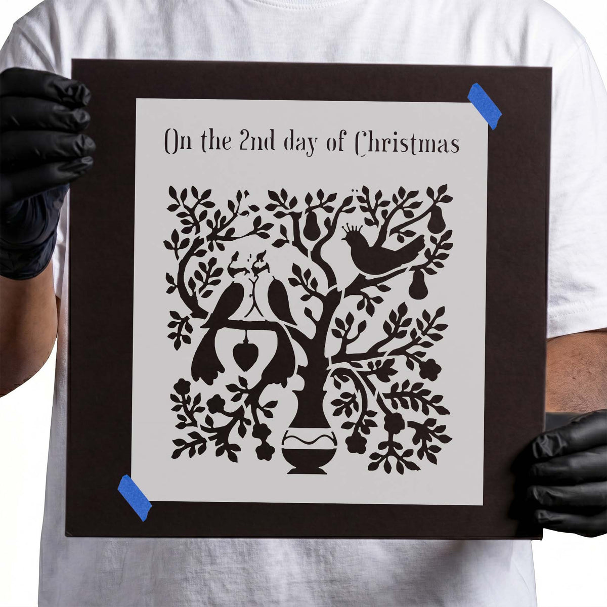 Two turtle doves perched in a leafy Christmas tree stencil design