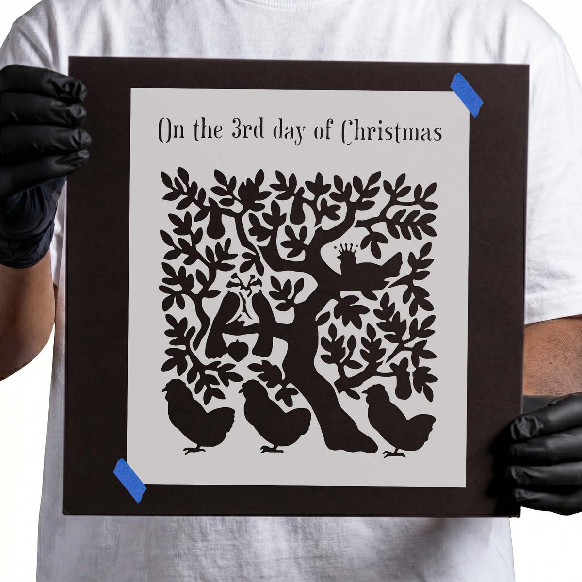 Three French hens beneath a leafy tree in a Christmas stencil design