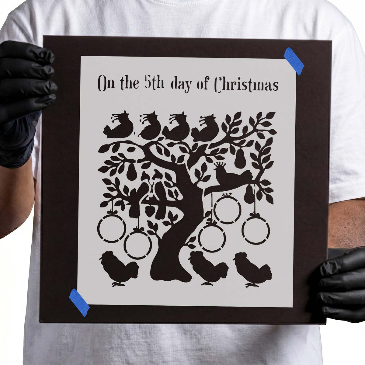 Christmas stencil with leafy tree, birds, hanging rings, and fruit shapes