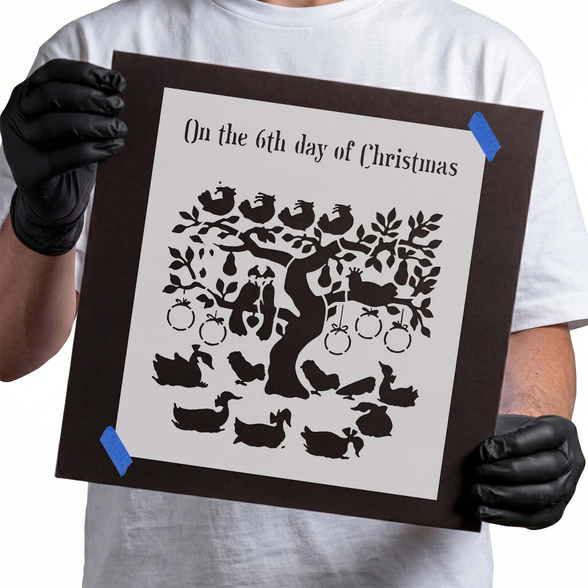 Christmas stencil with geese gathered around a leafy fruit tree