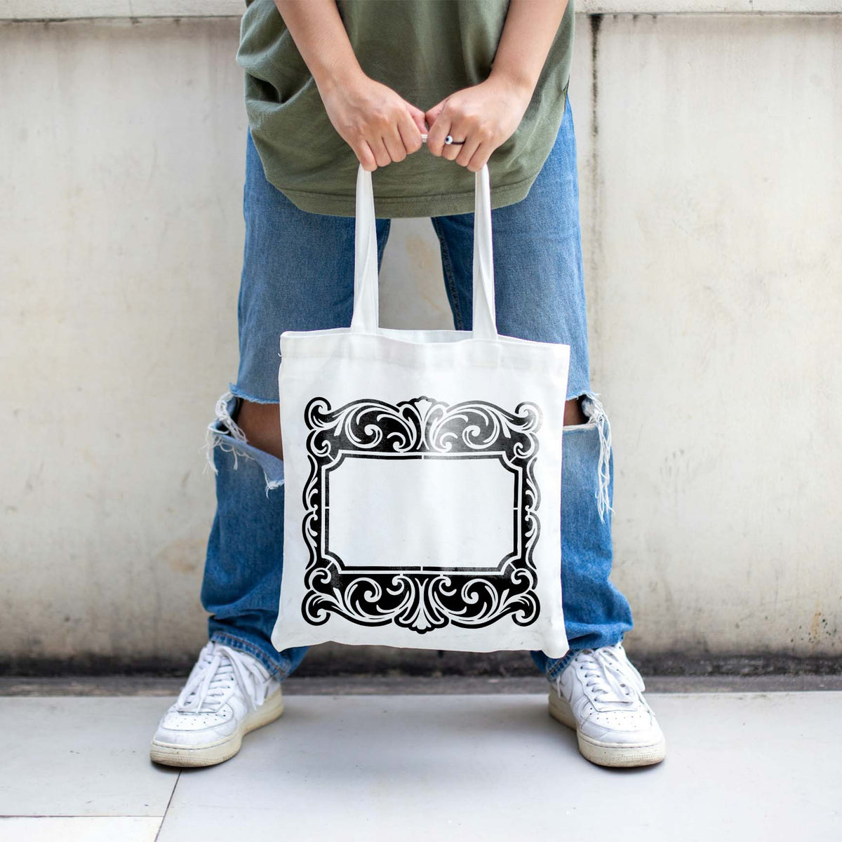 Ornate Family Name Plaque Stencil adds a detailed vintage-style border to a white tote bag