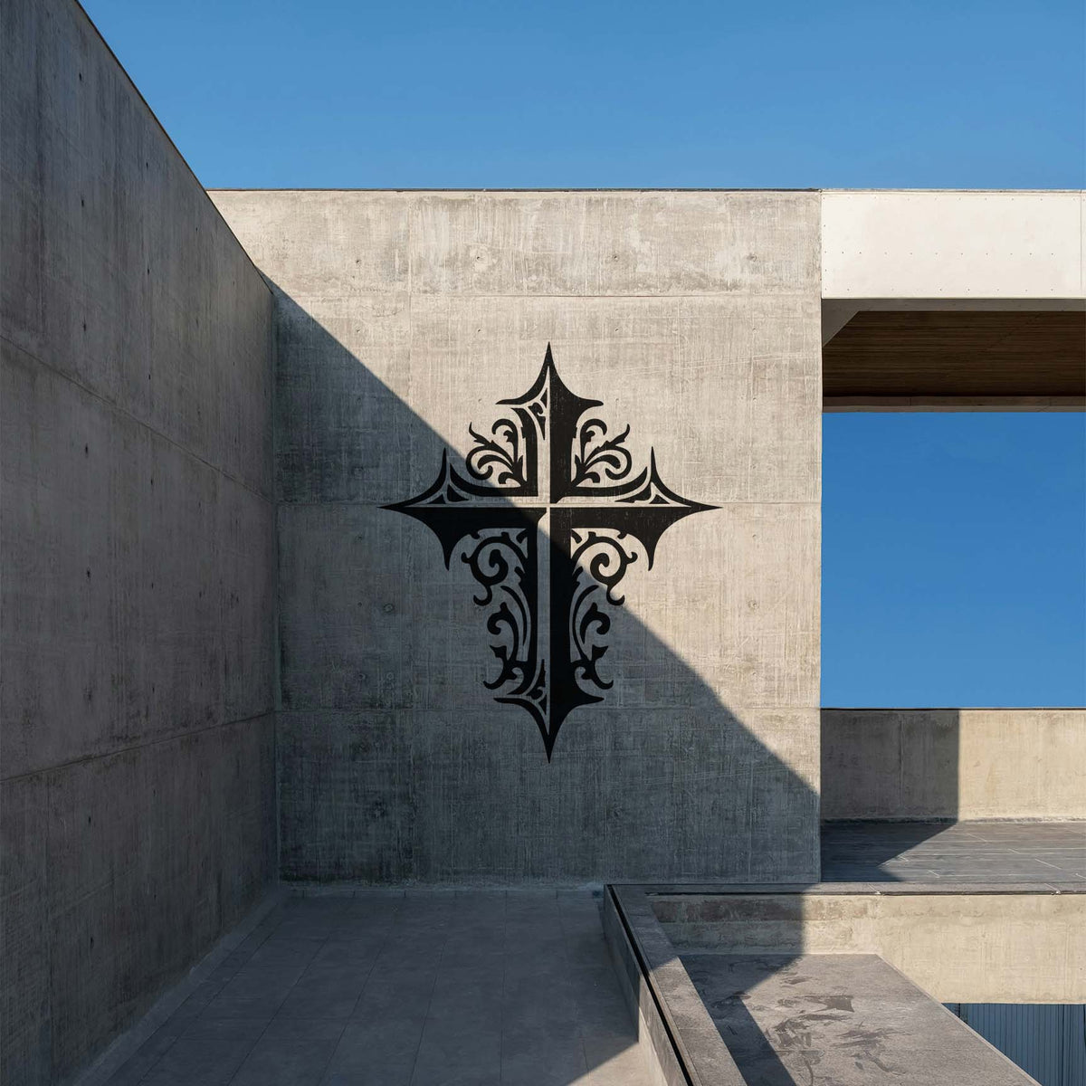Ornate Gothic Cross Stencil painted in black across a modern concrete wall