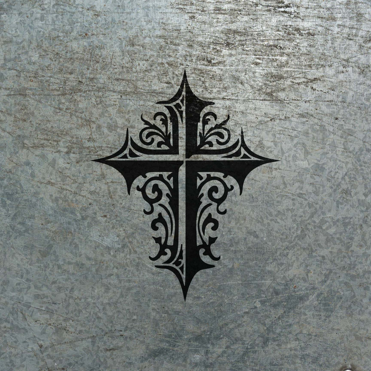 Weathered metal showcases the Ornate Gothic Cross Stencil in a bold distressed black finish