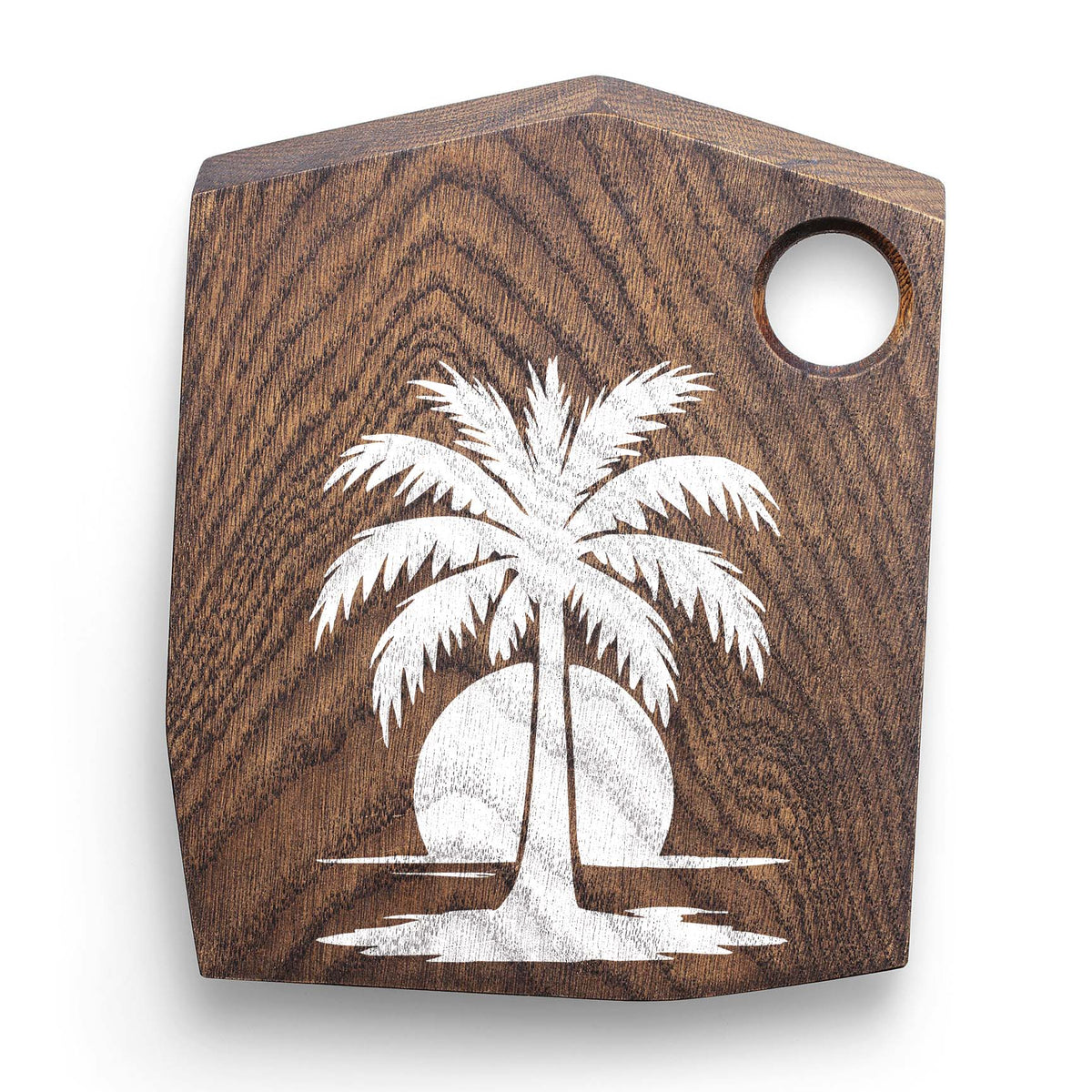 Palm Tree at Sunset Stencil painted white on a dark wooden cutting board