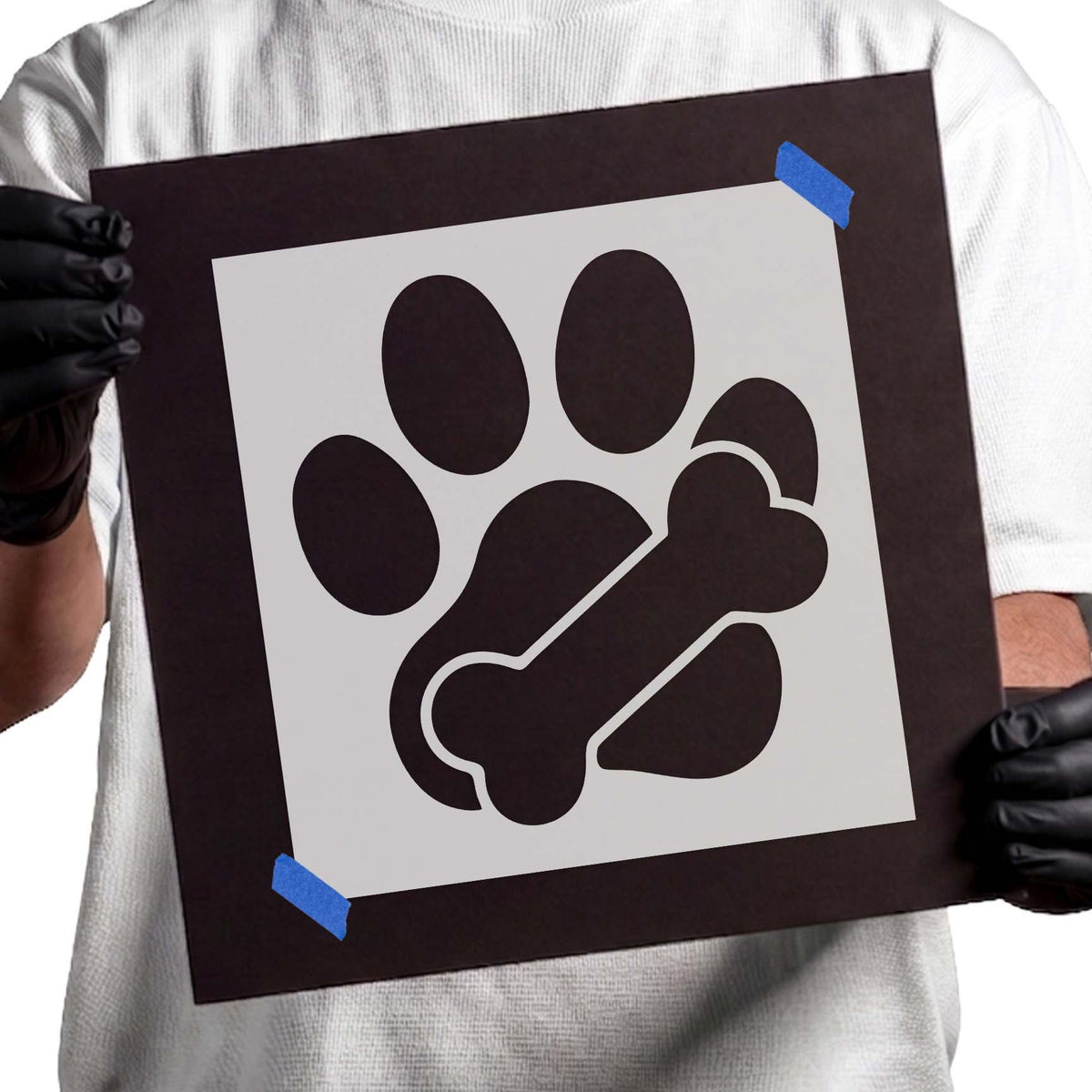 Dog paw stencil with four rounded toes and diagonal bone detail