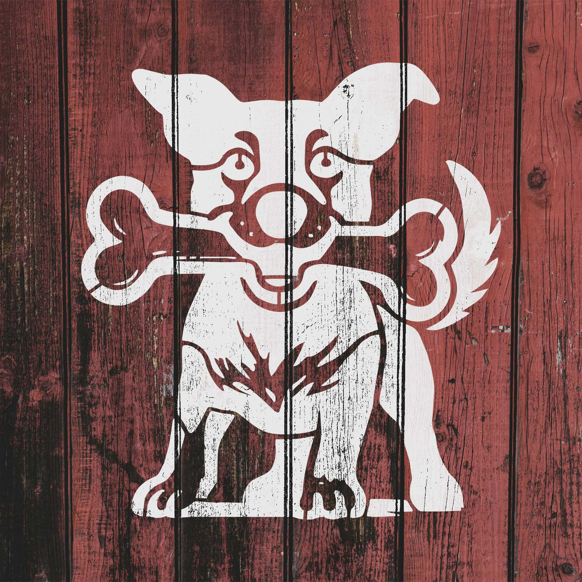 Playful Dog with Bone Stencil shown in white across weathered red fence boards.