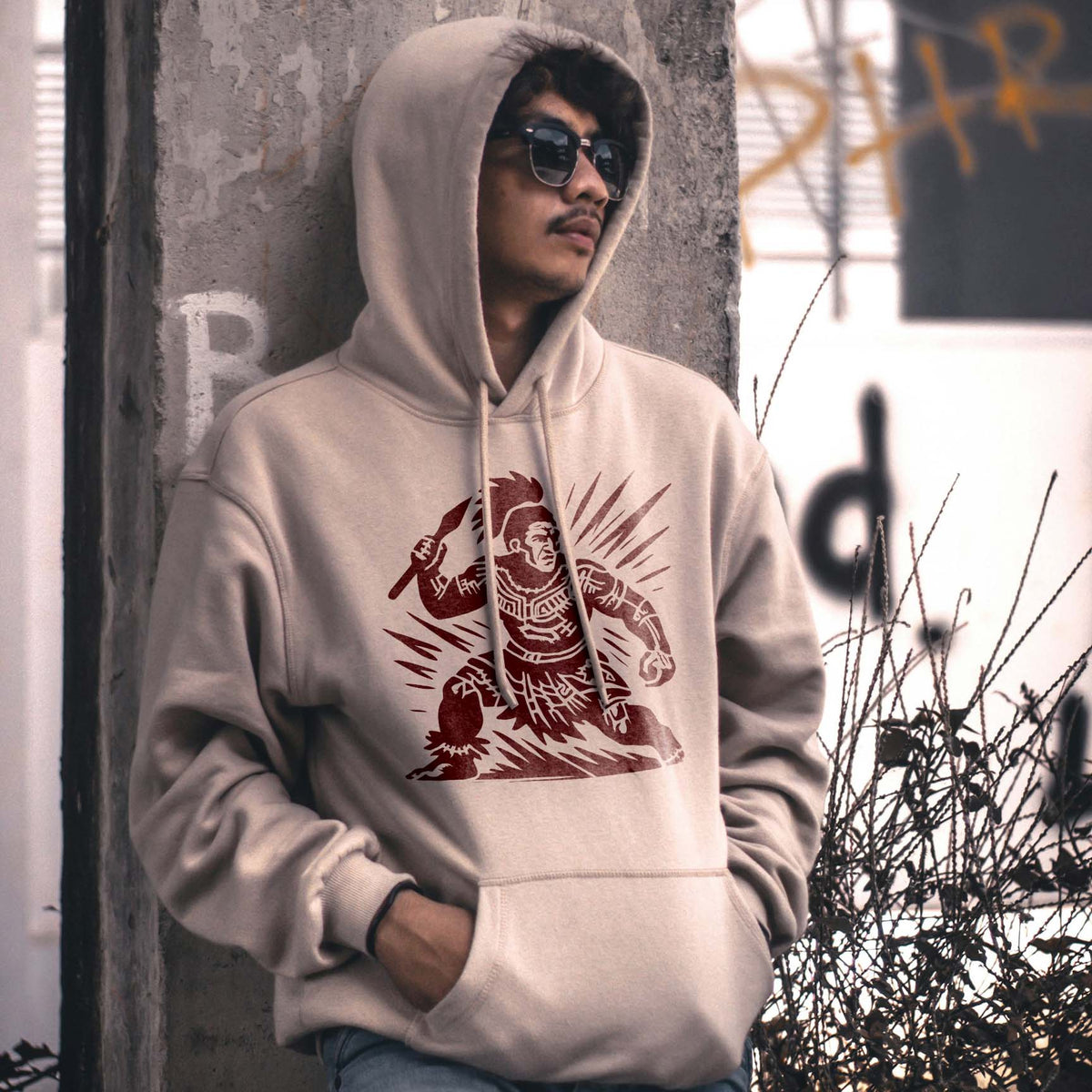 Polynesian Spear Warrior Stencil printed dark red on the front of a beige hoodie.