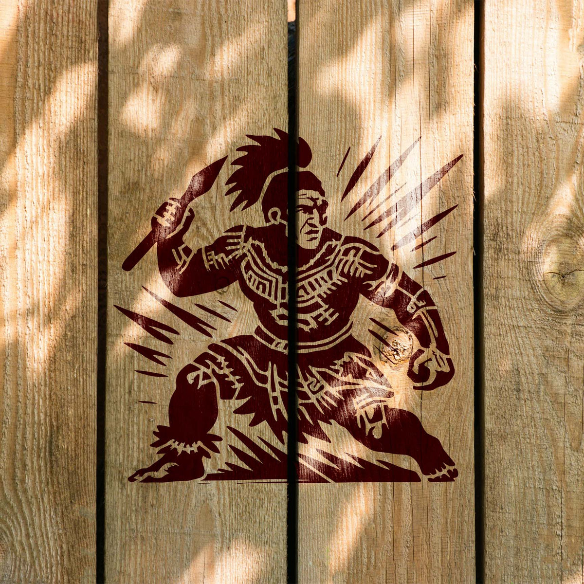 Polynesian Spear Warrior Stencil painted dark red across vertical wooden boards.