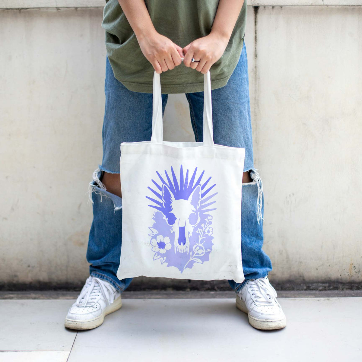 Radiant Animal Skull and Wildflower Stencil gives a white tote bag a striking purple design