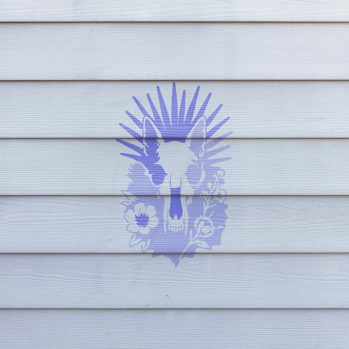 Purple Radiant Animal Skull and Wildflower Stencil displayed boldly across white exterior siding