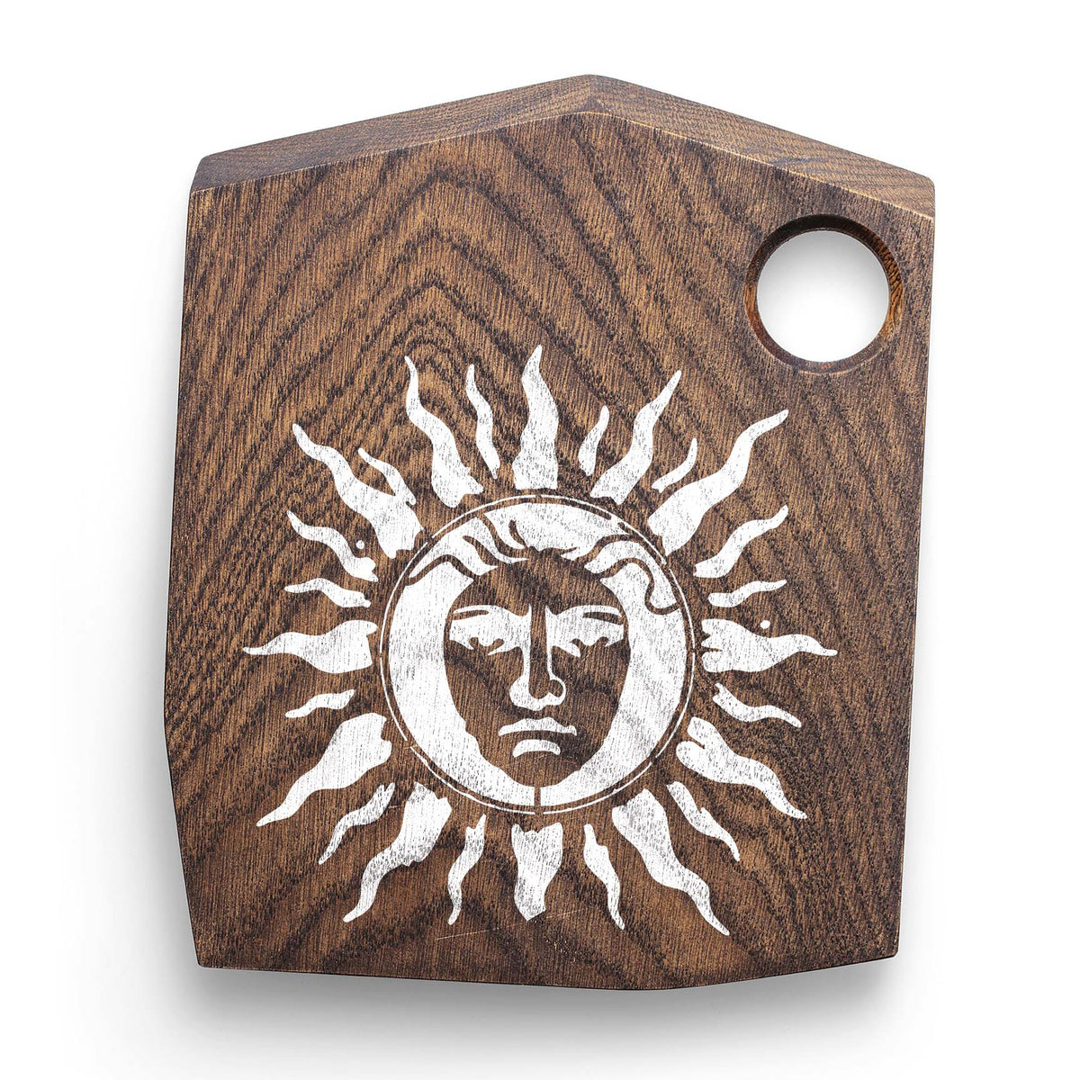 White Radiant Sun Face Stencil stands out on a dark rustic wooden cutting board