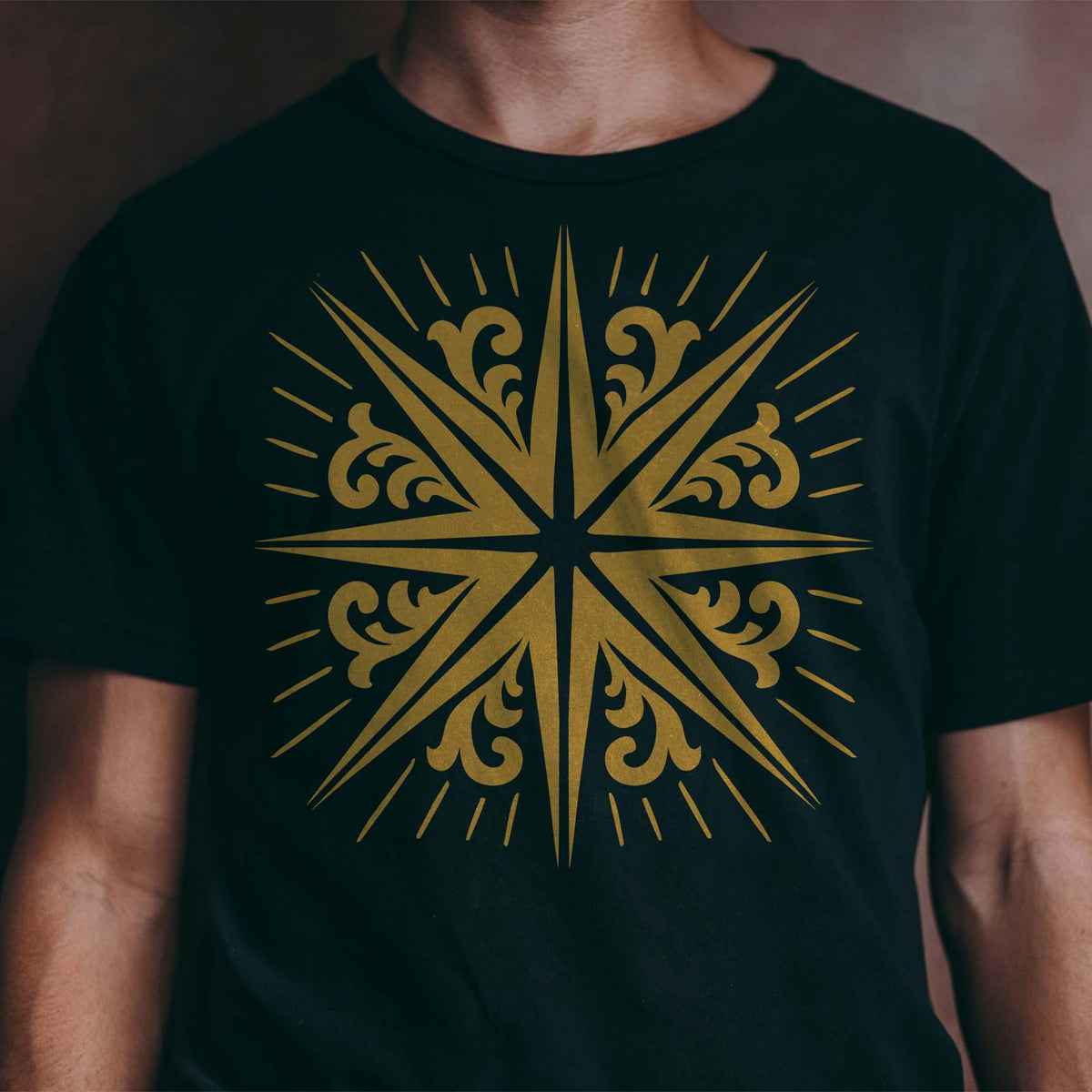 Golden Radiating Scroll Star Stencil makes a bold centerpiece across a black T-shirt