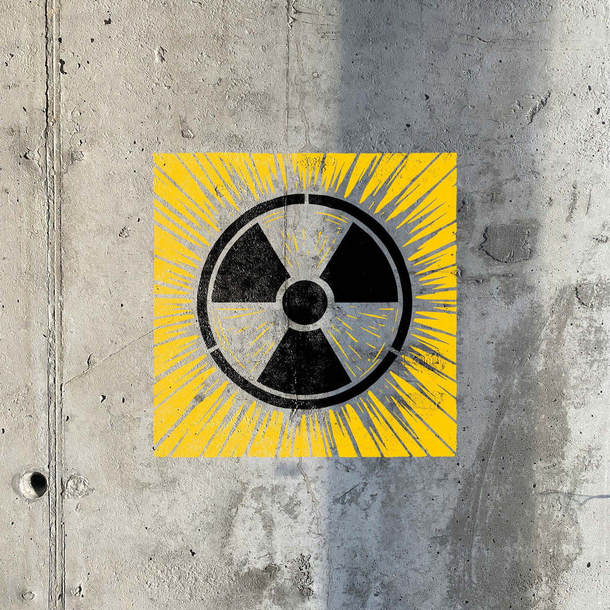 Radiation Warning Symbol Stencil marks raw concrete with a bold yellow and black hazard design