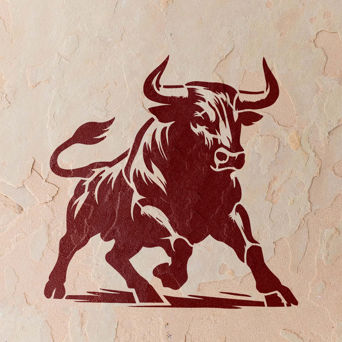 Painted in deep red, the Raging Bull Stencil captures a powerful bull mid-charge on a textured stucco wall.