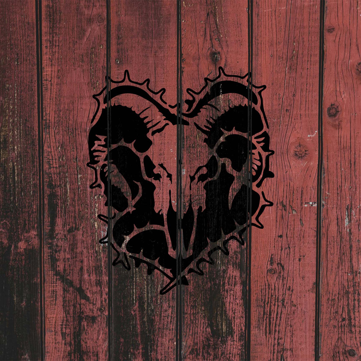 Dramatic Ram Skull Thorn Wreath Stencil appears in black across distressed red wooden planks