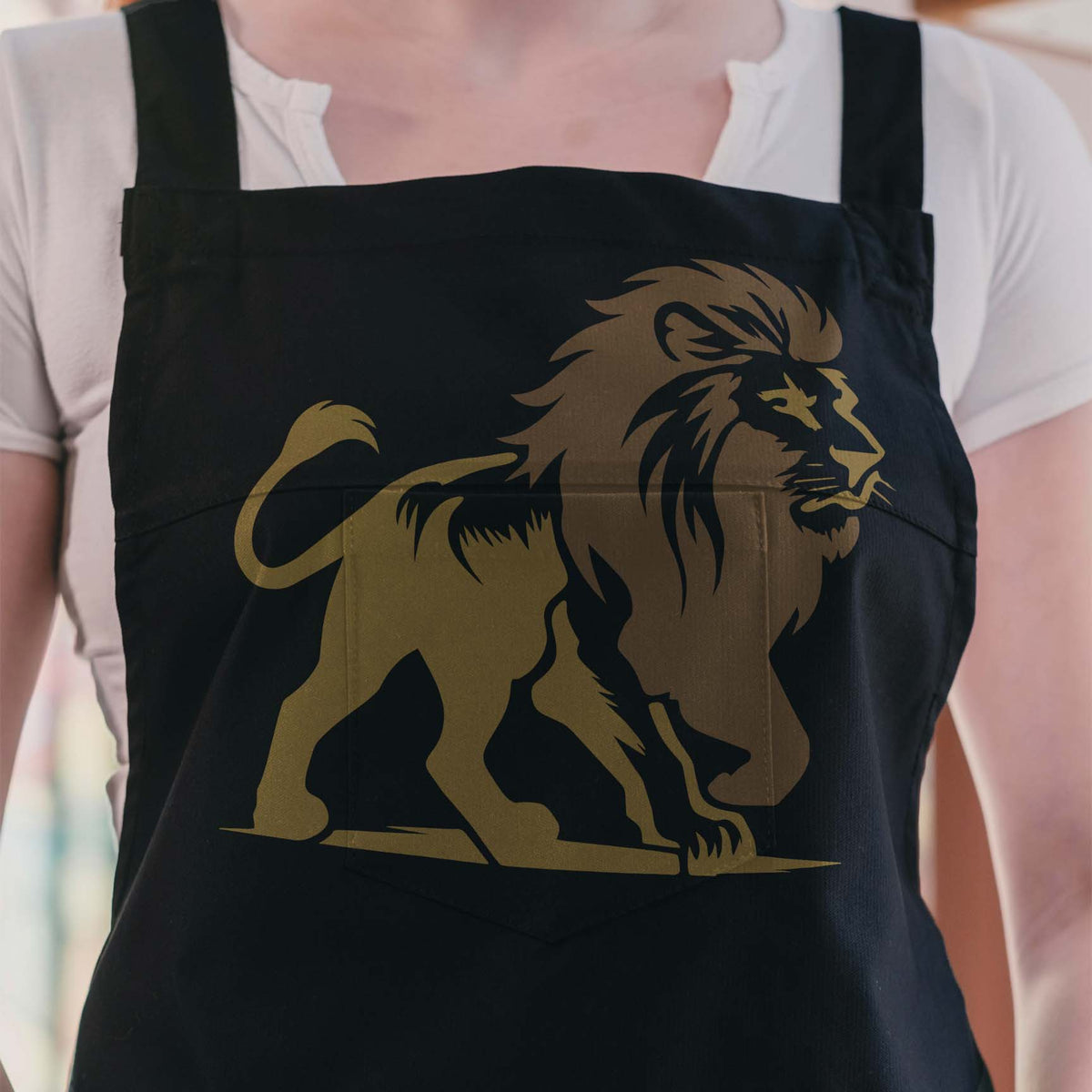 Golden Regal Walking Lion Stencil stands boldly across the front of a black apron.