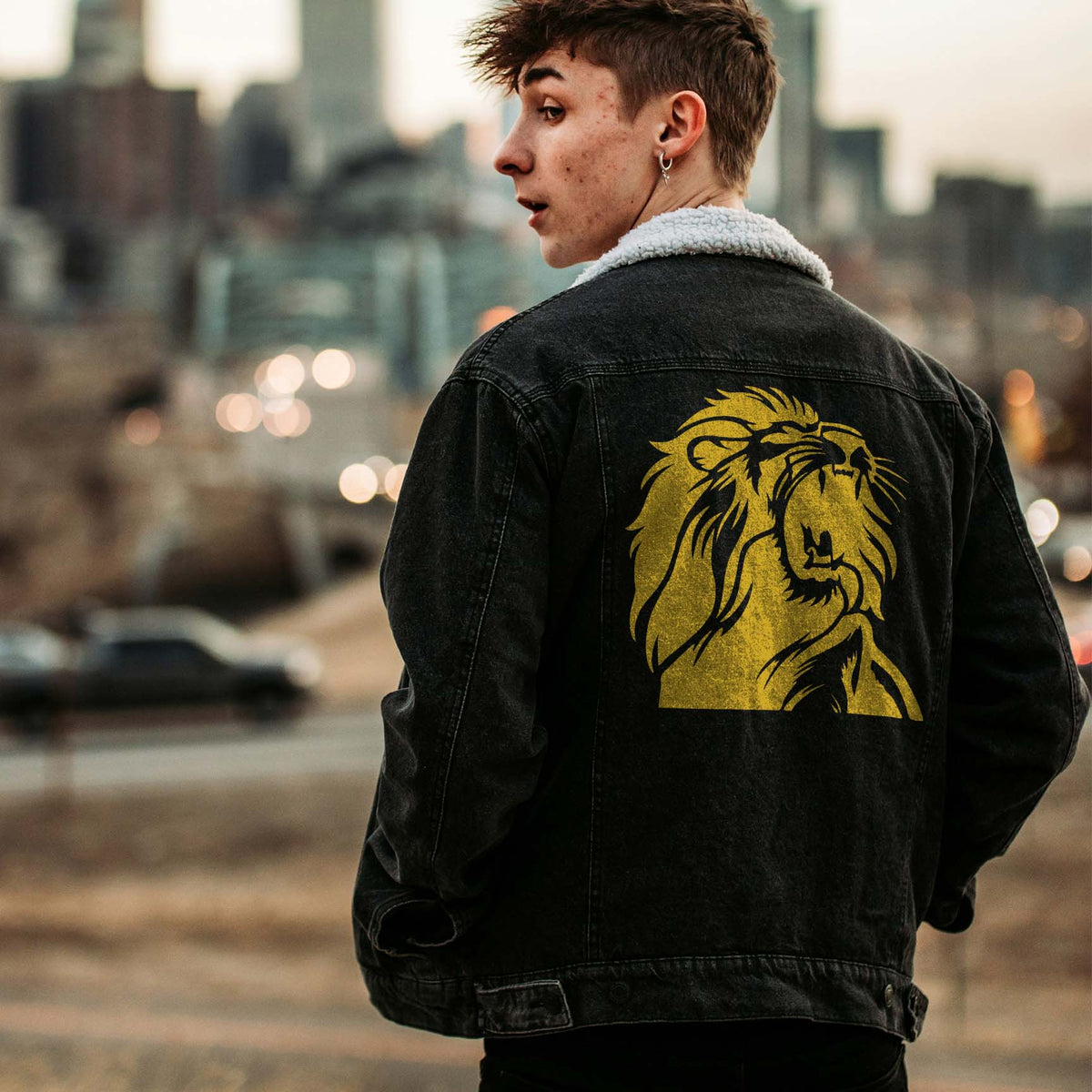 Roaring Lion Head Stencil in gold commands attention across the back of a black denim jacket.