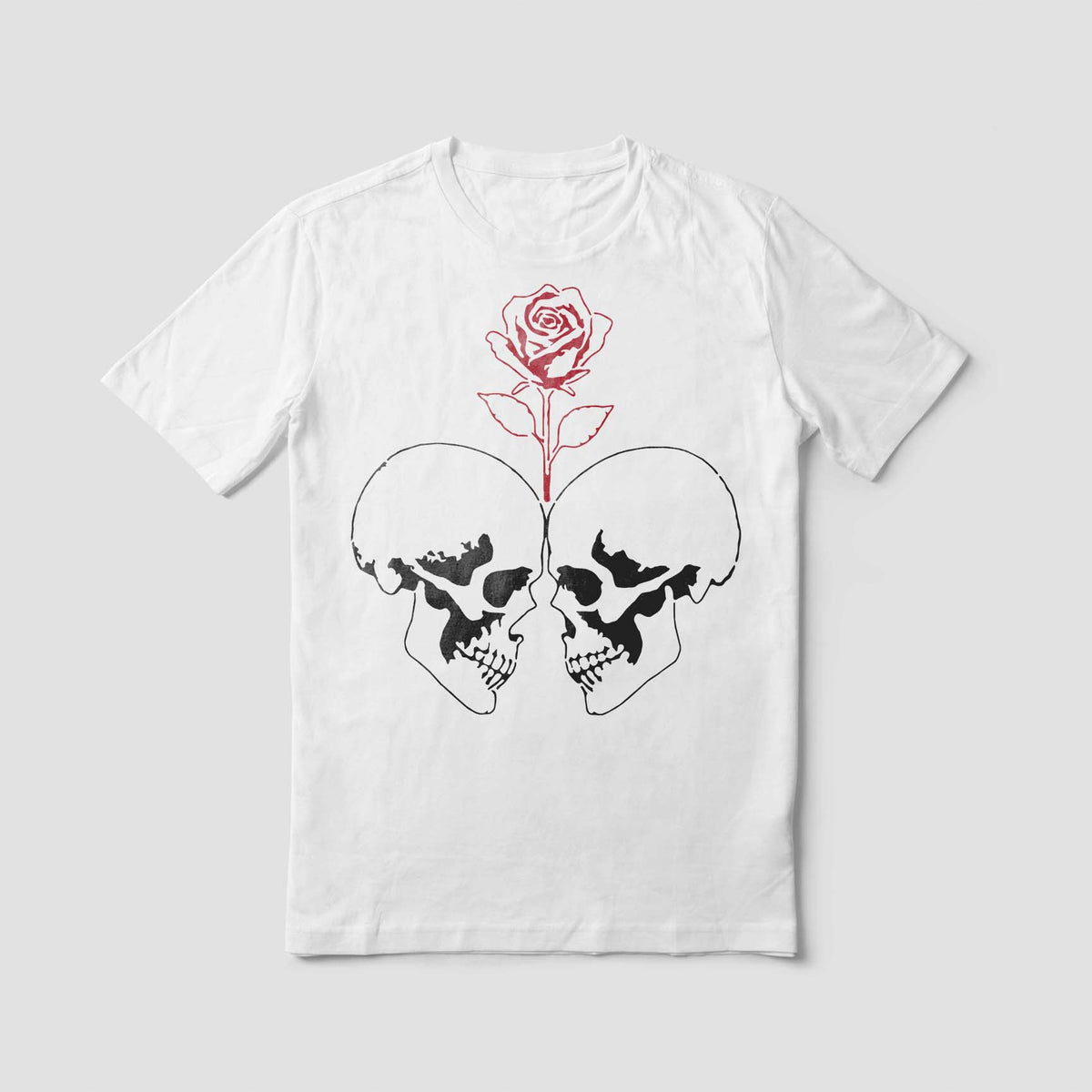A white shirt displays the Rose Between Twin Skulls Stencil with bold black skulls and a red rose