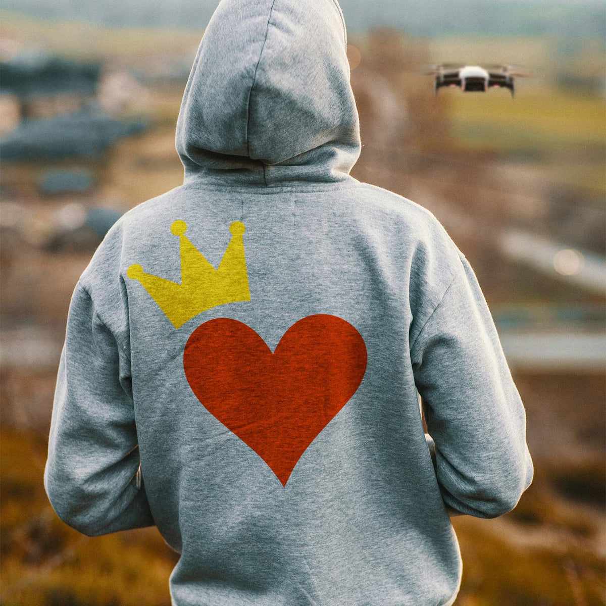 A gray hoodie features the Royal Heart Stencil with a bright crown above a red heart