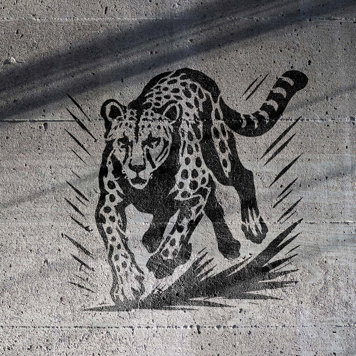 Running Cheetah Wildlife Stencil painted in black on textured concrete wall