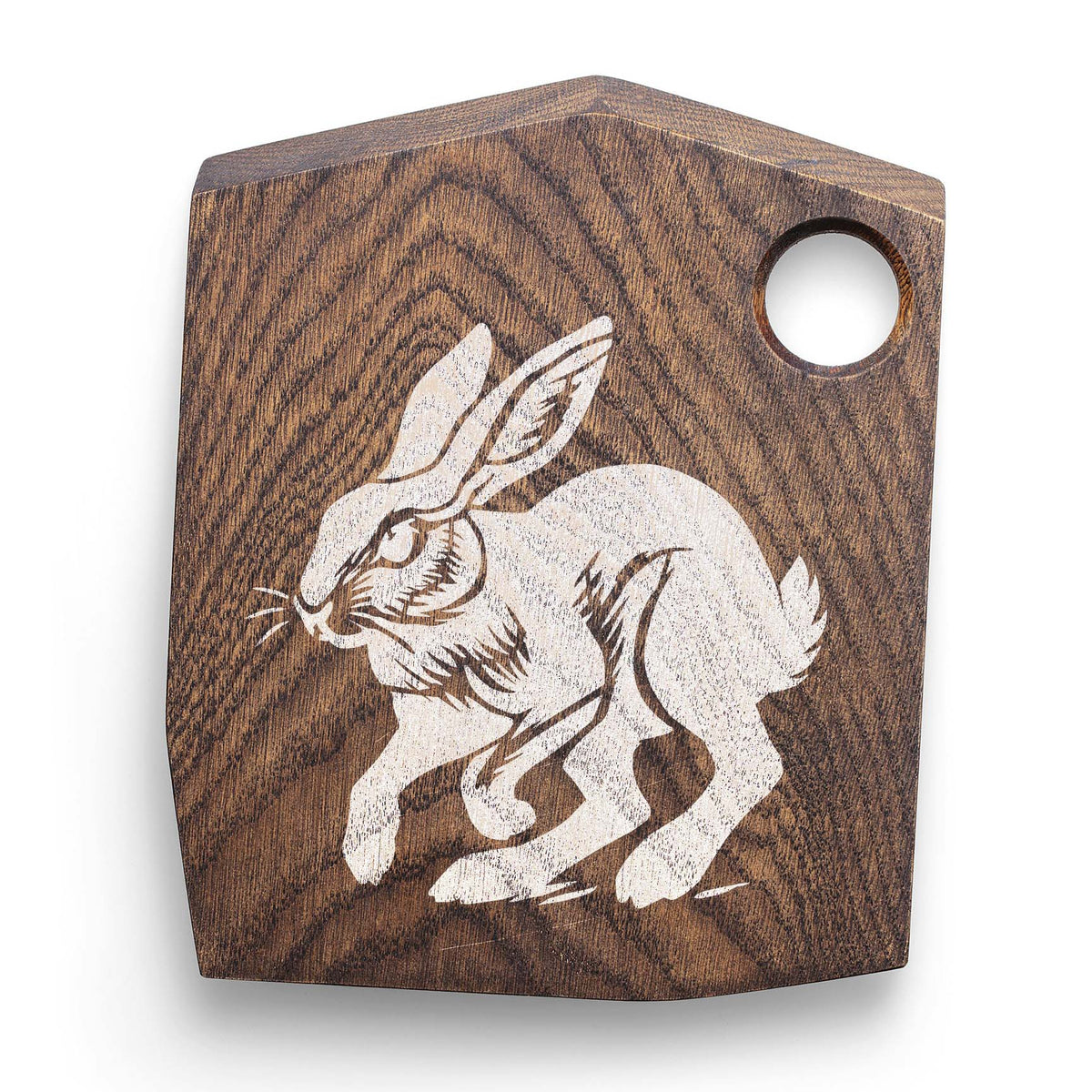 Rustic running jackrabbit stencil painted in white on a wooden cutting board
