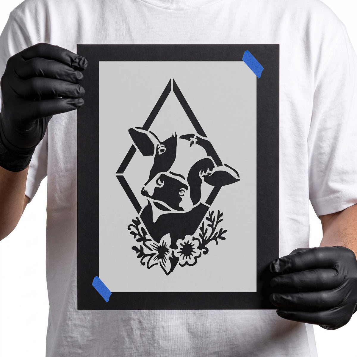 Rustic cow stencil featuring two overlapping cow heads, a diamond frame, and floral accents