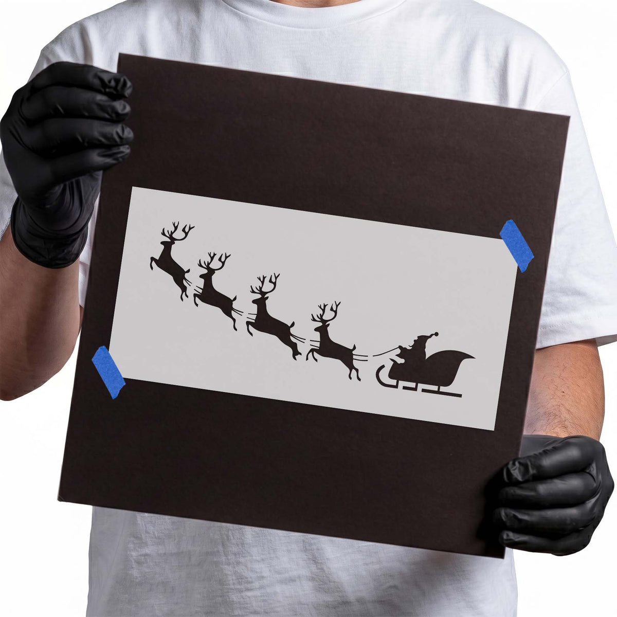Santa sleigh stencil with four flying reindeer in silhouette