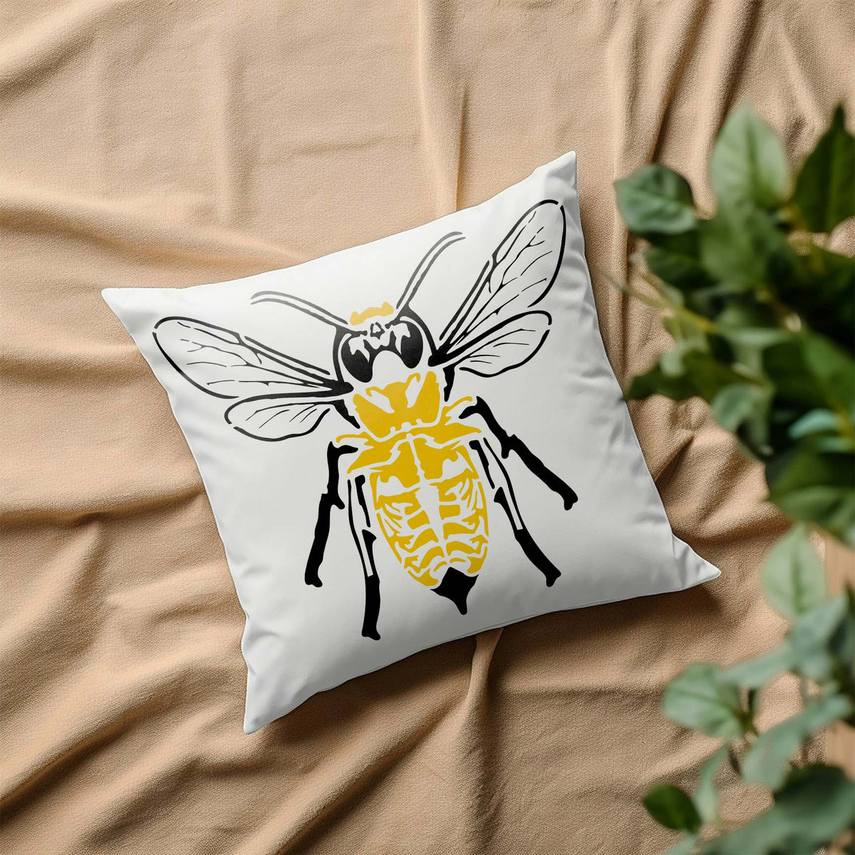 Skeleton Bee Stencil stands out in yellow and black across a crisp white decorative pillow
