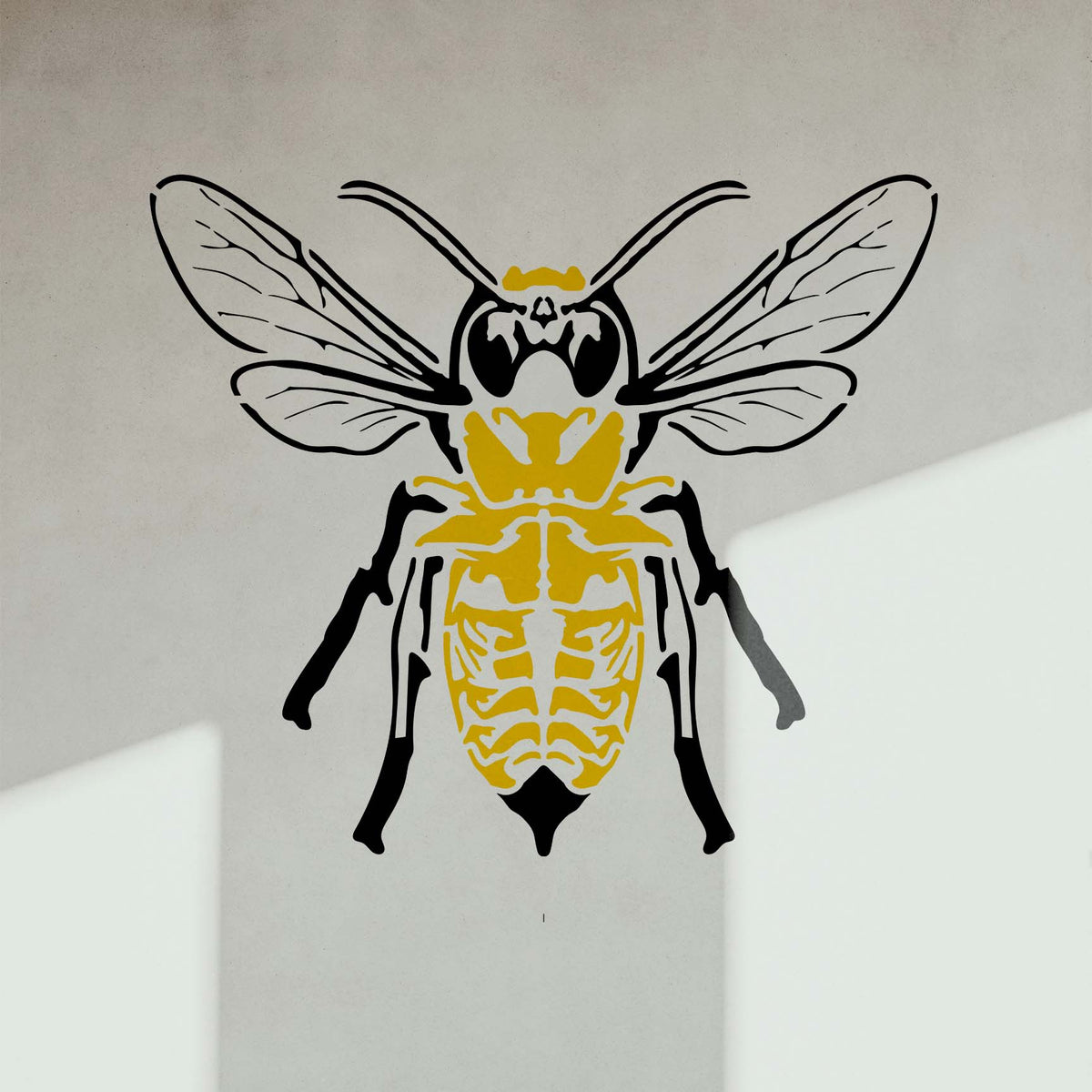 Sunlit Skeleton Bee Stencil brings a striking yellow and black insect design to a smooth wall