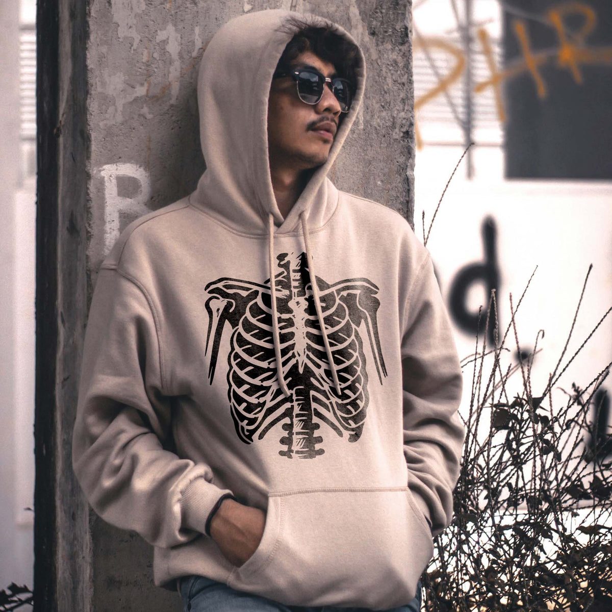 Skeleton Ribcage Stencil spans a beige hoodie with bold black anatomical bone details