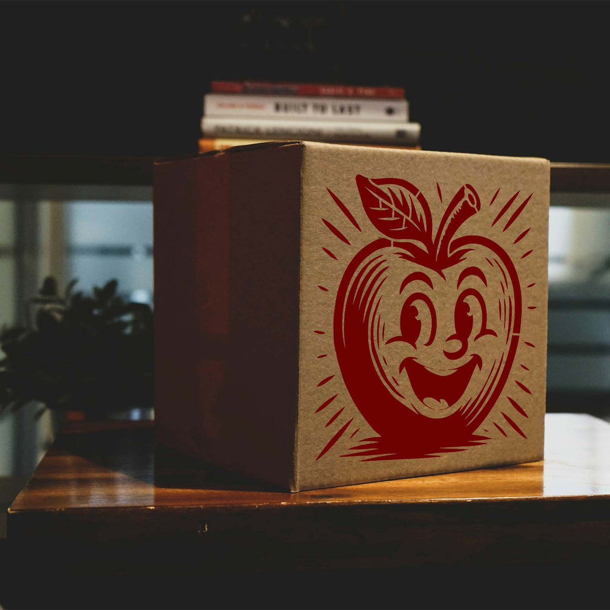A cheerful red Smiling Cartoon Apple Character Stencil brightens a brown cardboard packaging box