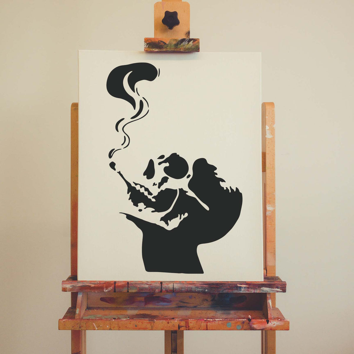 Smoking Skull Silhouette Stencil shows a dark skull exhaling smoke on an artist canvas