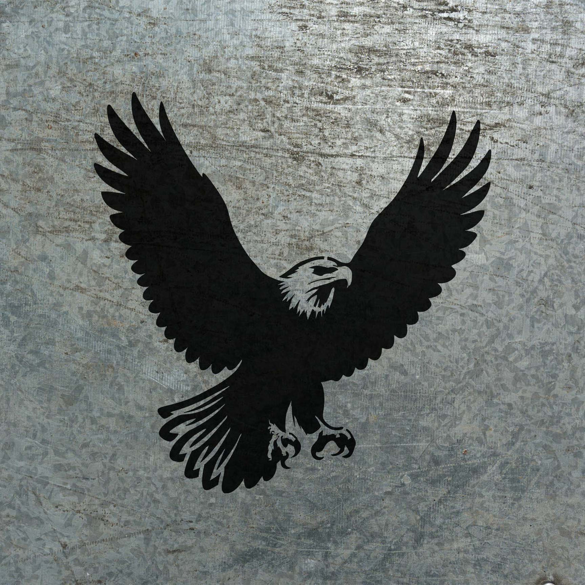 Against weathered metal, the Soaring Bald Eagle Stencil reveals a striking black eagle in midflight.