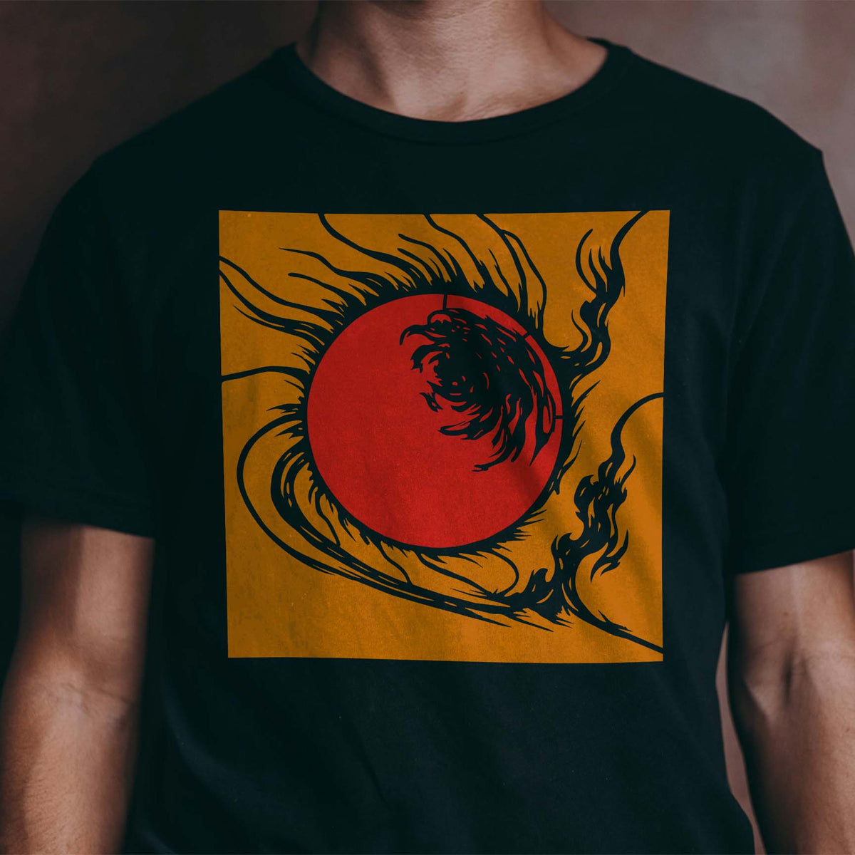 Solar Eclipse Burst Stencil blazes in orange and red with swirling flames across a black shirt
