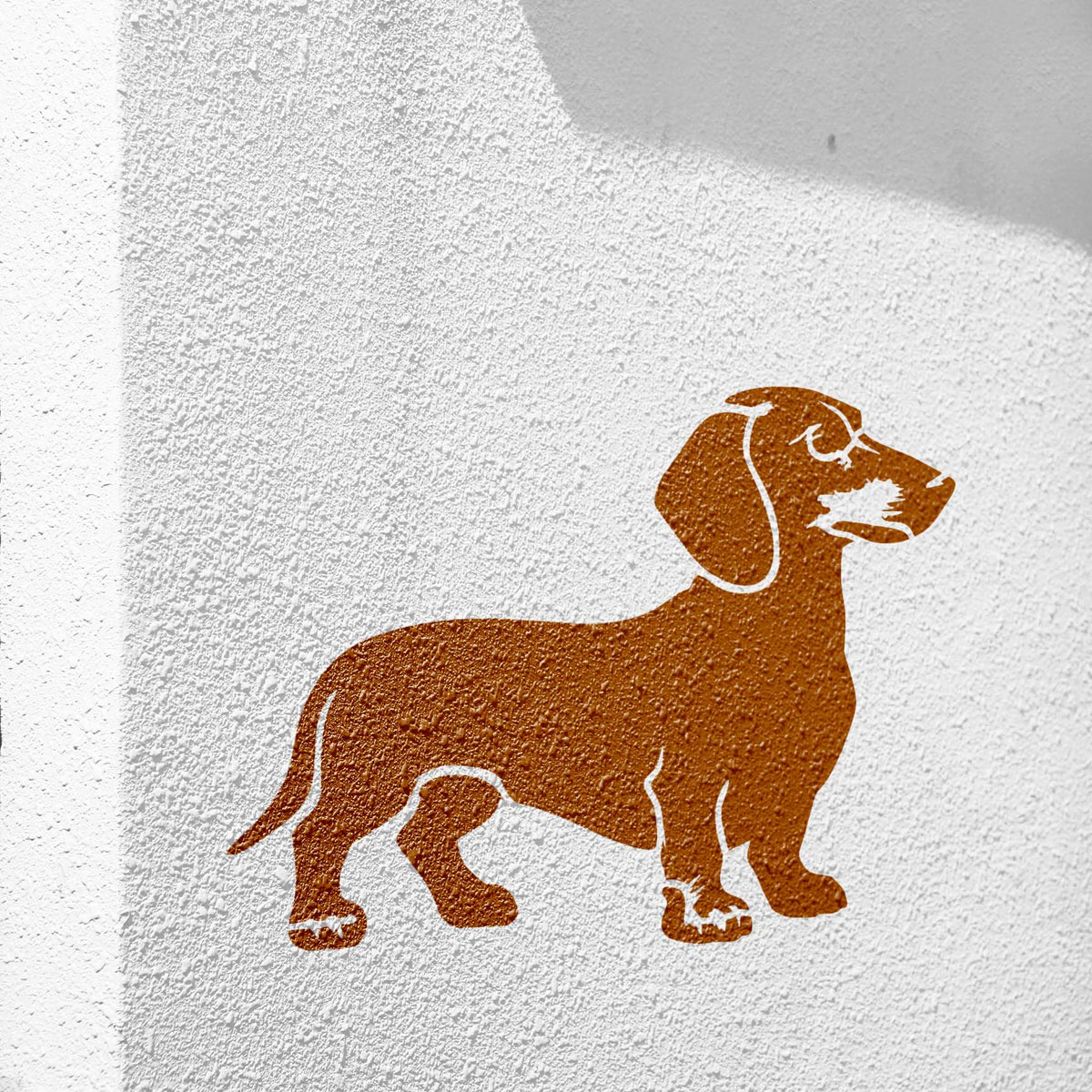 Standing Dachshund Stencil painted in brown on a white textured wall.