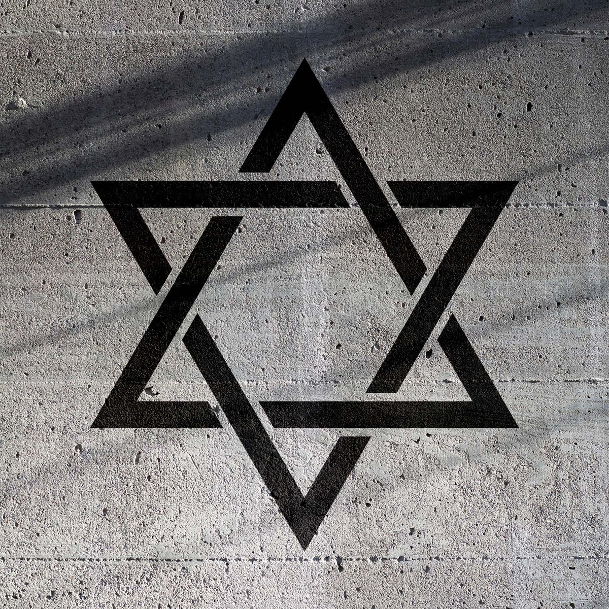 Bold Star of David Symbol Stencil painted black across a textured concrete wall