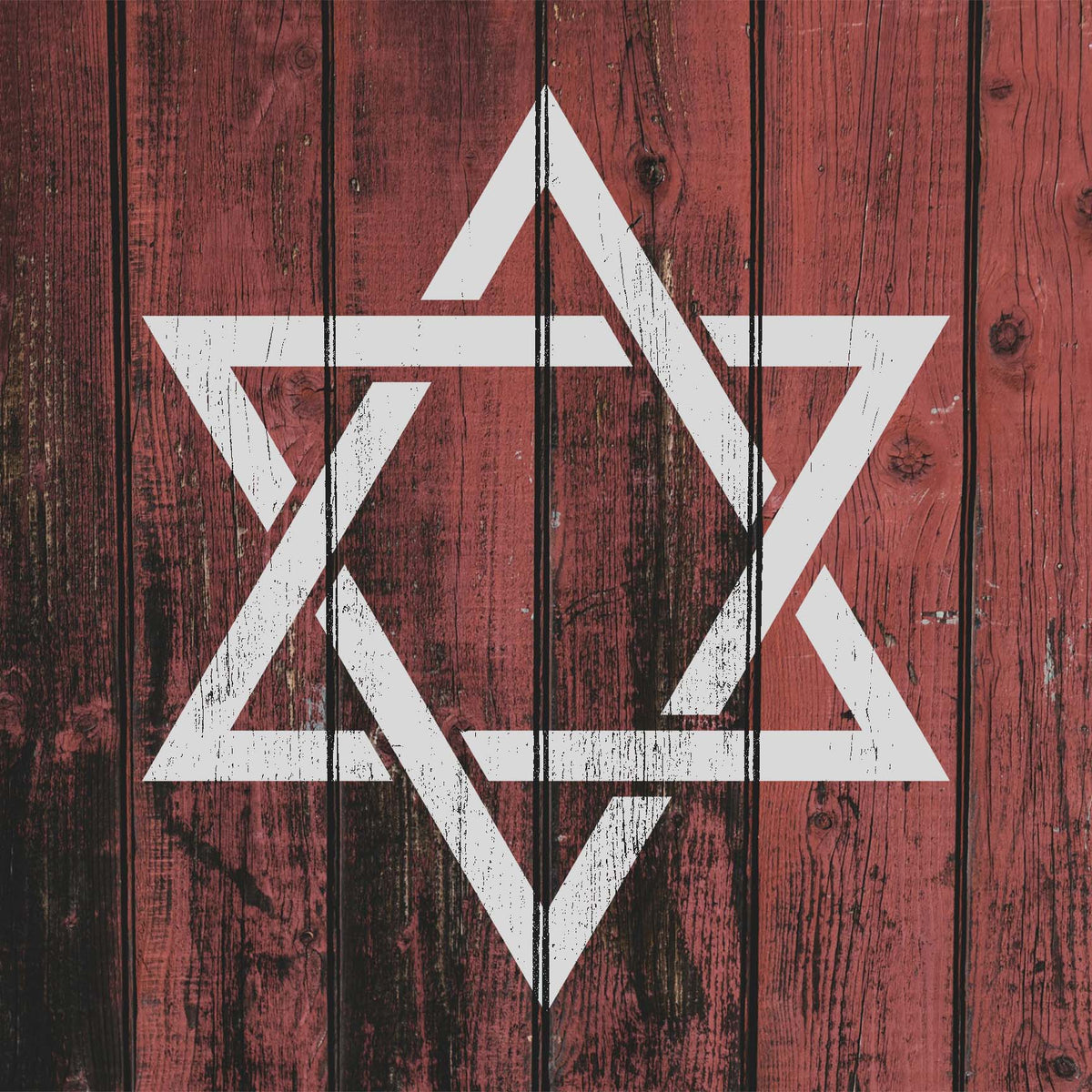 Rustic red wood showcases the Star of David Symbol Stencil in a distressed white finish