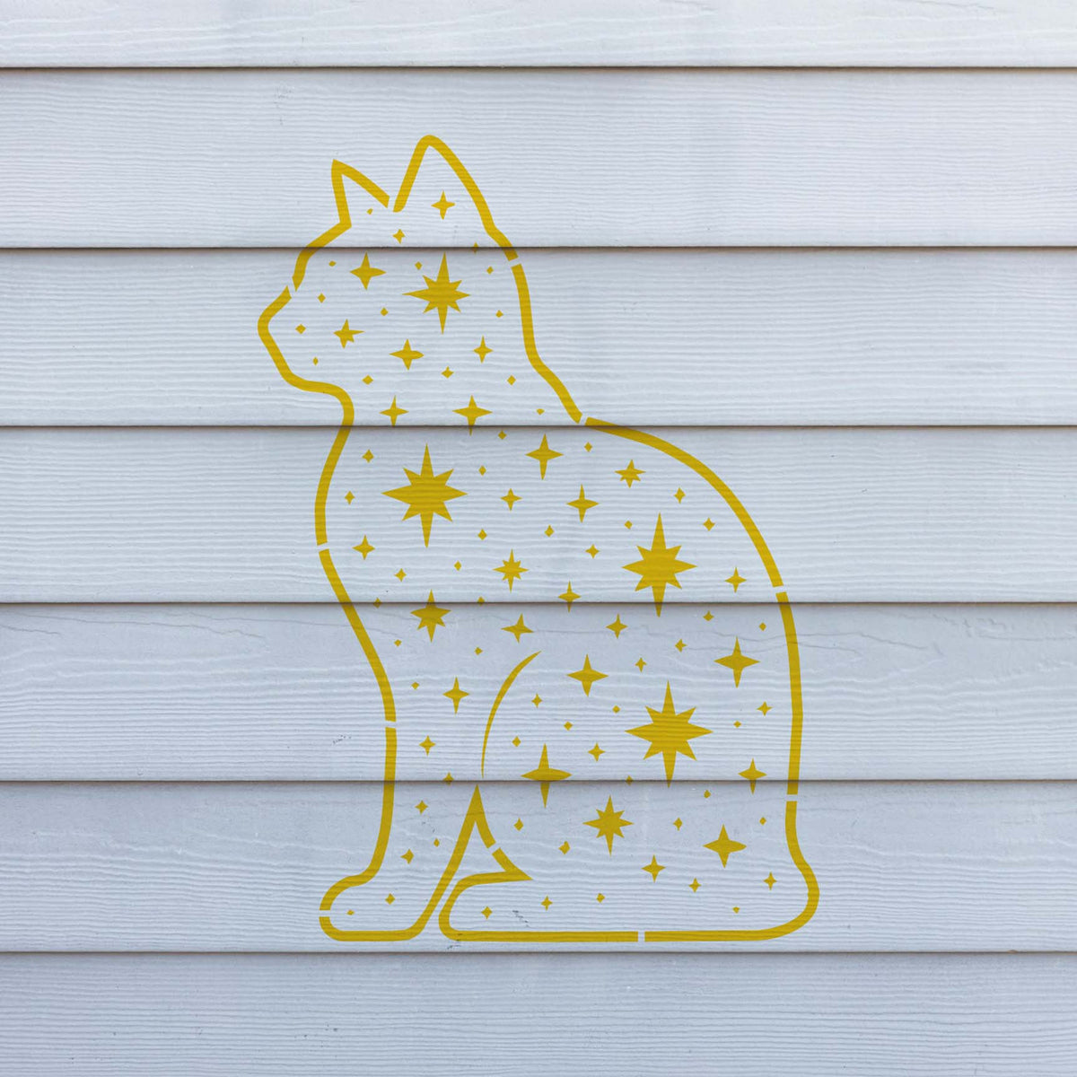 Starry Cat Silhouette Stencil shines in yellow with celestial details on white exterior siding