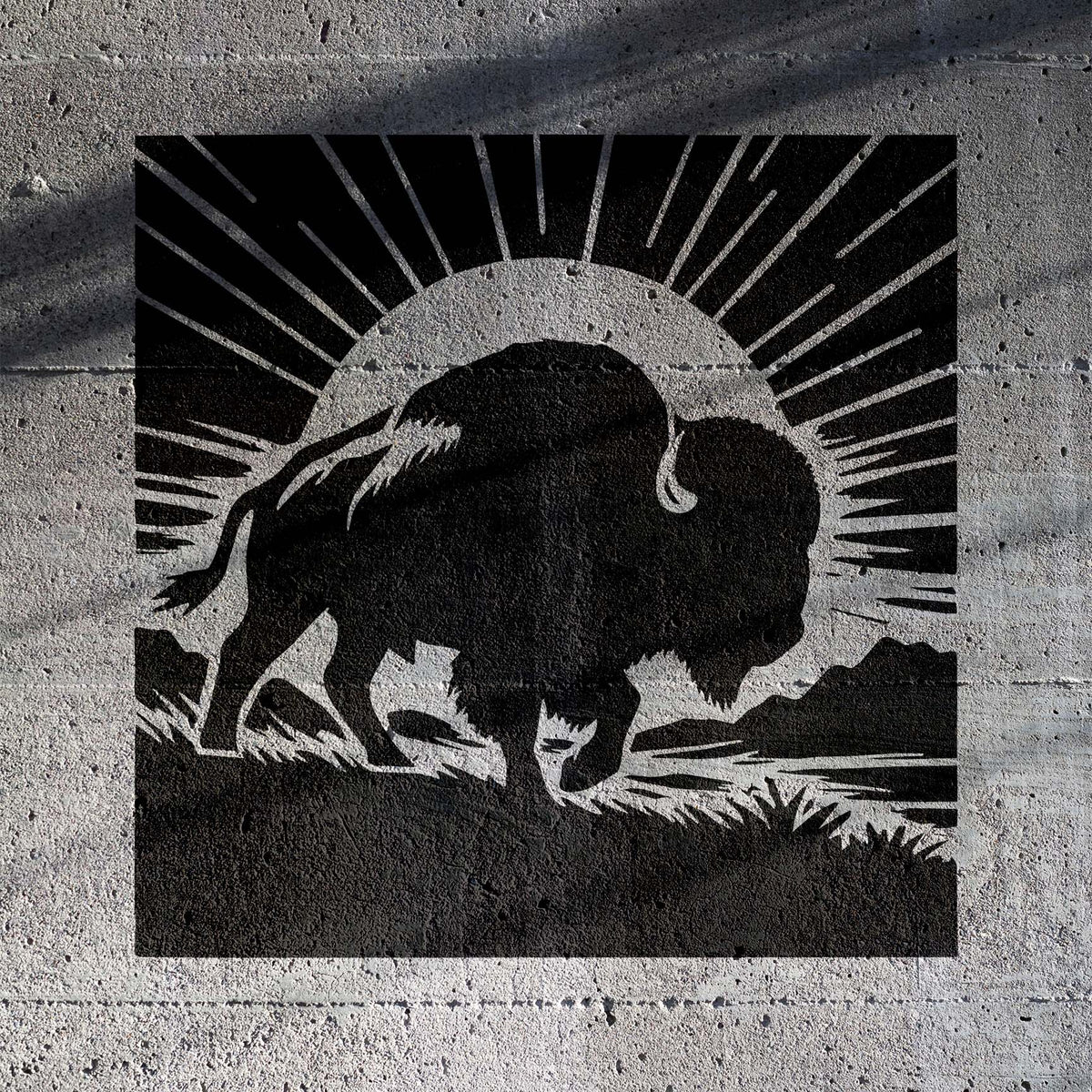 Sunrise Buffalo Silhouette Stencil captures a powerful bison against a rising sun on textured concrete.
