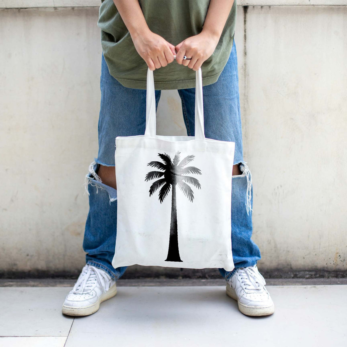 Minimalist palm tree stencil printed in black and gray on white tote bag