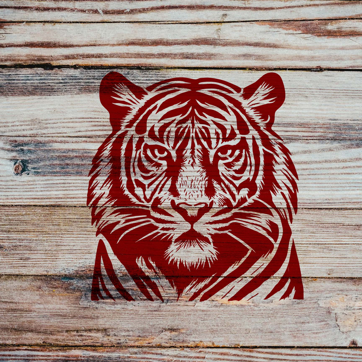 Detailed Tiger Face Wildlife Stencil in red painted on rustic wooden planks.