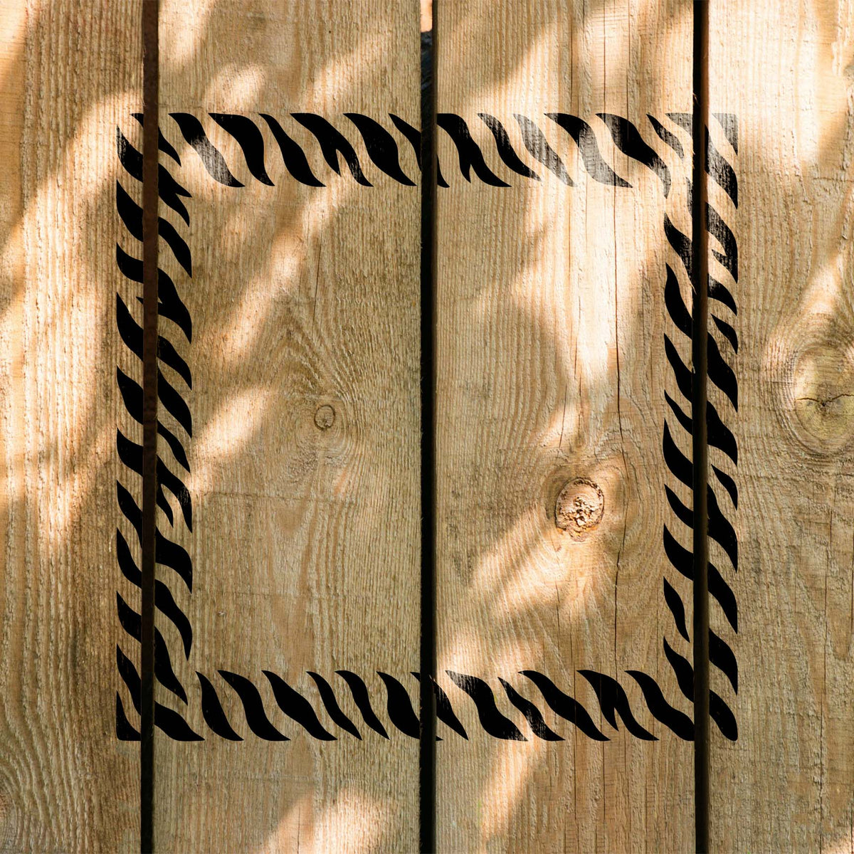 Bold Tiger Stripe Border Stencil forms a striking square frame across natural wood planks