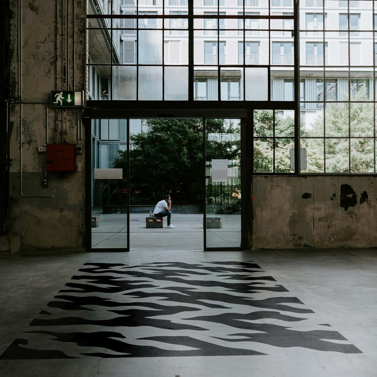 Oversized Tiger Stripe Camouflage Pattern Stencil sweeps across an industrial concrete floor