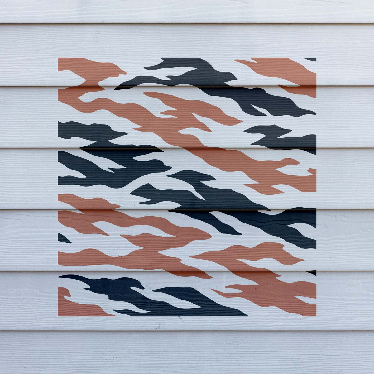 Dynamic Tiger Stripe Camouflage Pattern Stencil spreads bold flowing shapes across white siding