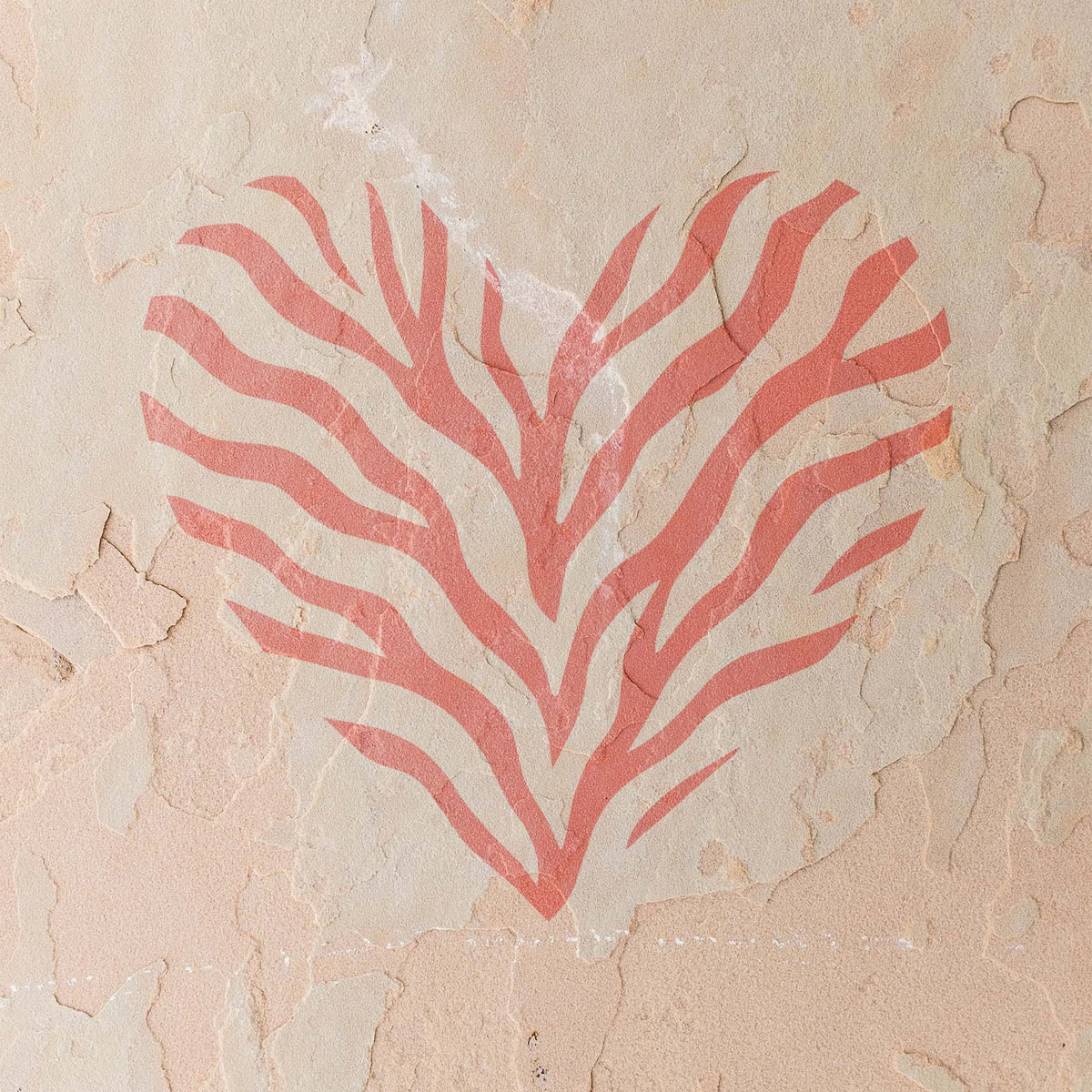 Coral Tiger Stripe Heart Stencil branches into bold stripes across a weathered stucco wall
