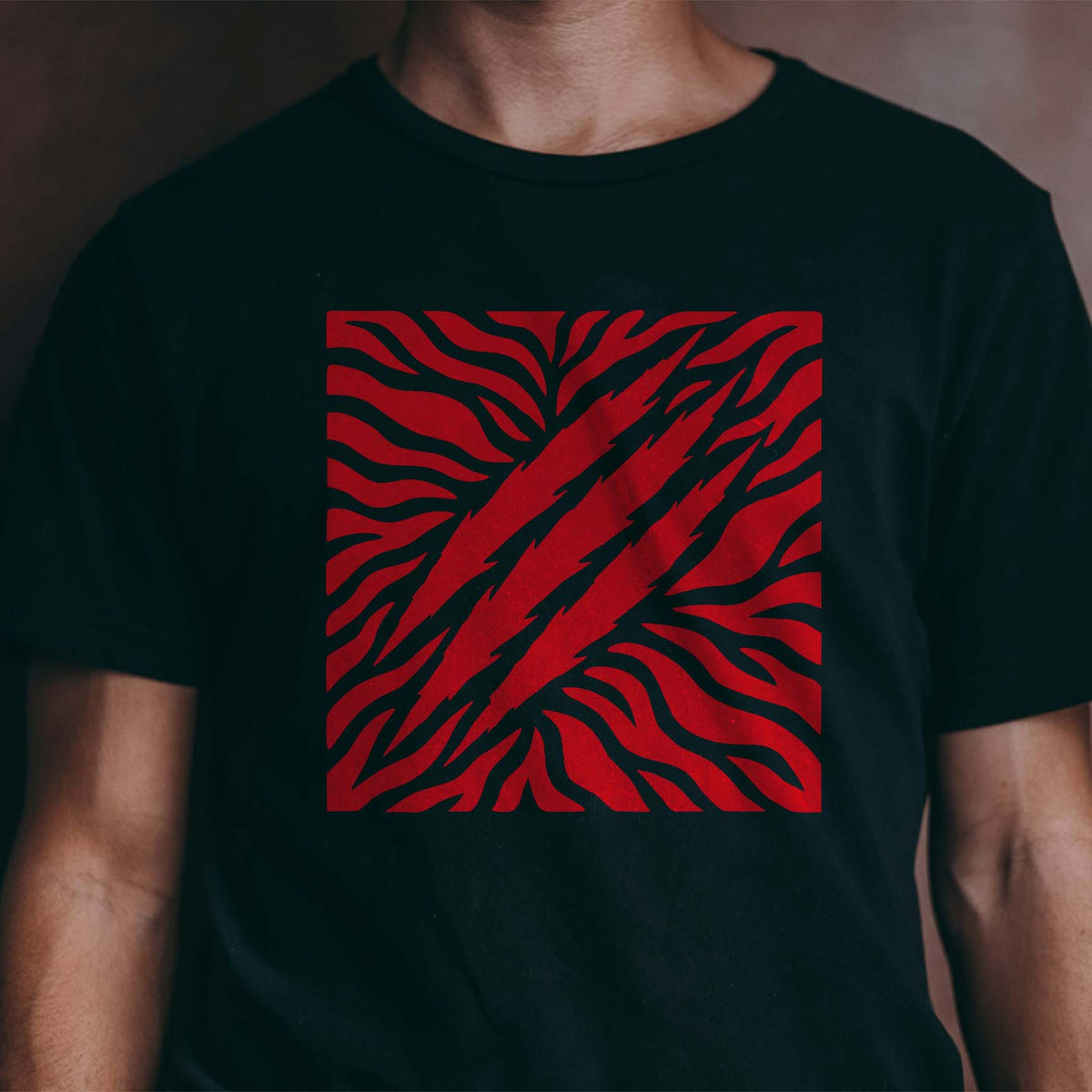 Tiger Stripes with Claw Marks Stencil stands out in vivid red across a black T-shirt