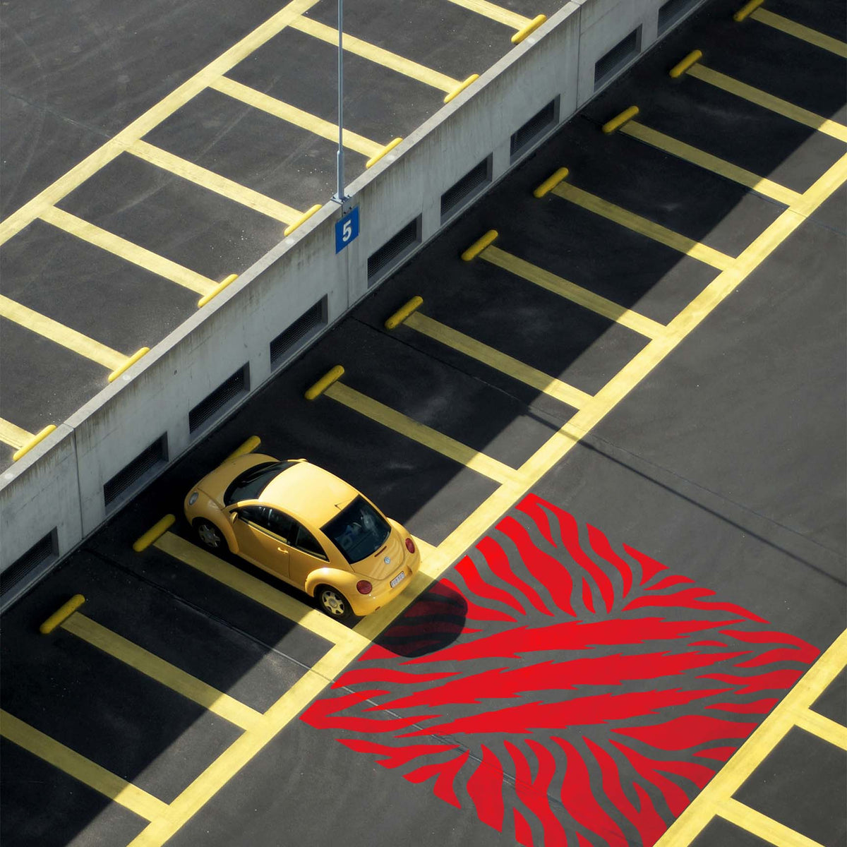 Parking lot pavement features the Tiger Stripes with Claw Marks Stencil in bold red