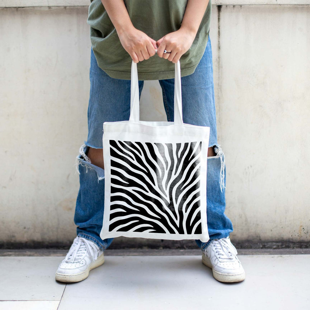 Black Tiger Stripe Pattern Stencil covers a white tote bag with flowing stripes